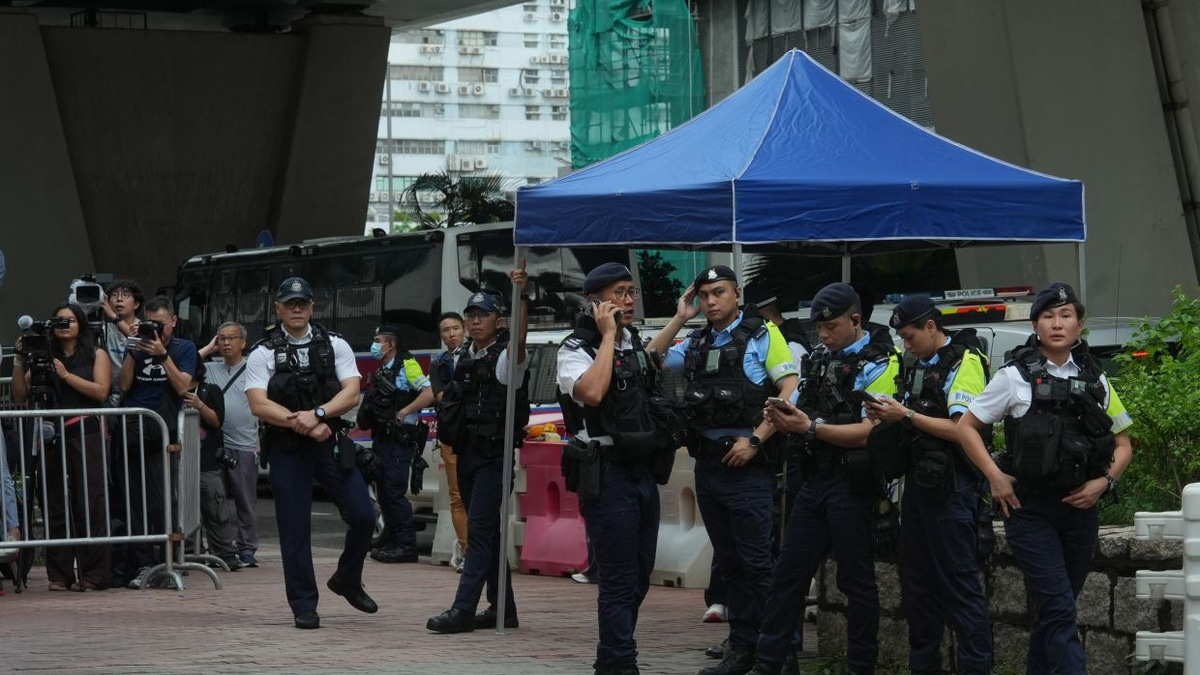 Hong Kong police arrest woman for seditious T-shirt outside court as democracy activists face conviction